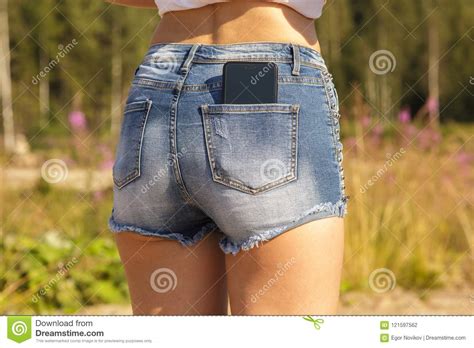 Download free photos of funny women. Beautiful Girl With A Black Smartphone In The Back Pocket Of A Jeans Stock Photo - Image of ...