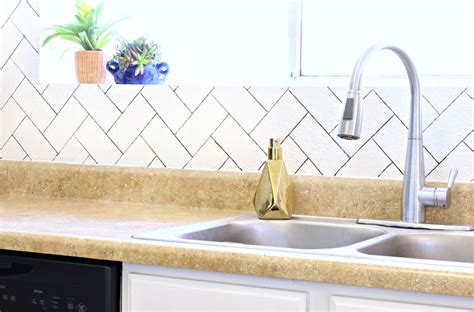 Here, marble subway tiles take on a straight herringbone design. DIY Herringbone Faux Backsplash - A Beautiful Mess