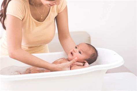 Wet the washcloth, wring out excess water and wipe your baby's face. How To Keep Water Out Of Baby's Ears During Bath & Common ...