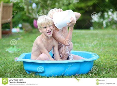 Claire rosinkranz & jeremy zucker] dance with me in my backyard boy looking super fine in your corduroy drive me around the block, we can go in a loop and we'll turn the volume up, on some good boy band tunes. Two Brothers Splashing Water In Summertime Stock Photo ...