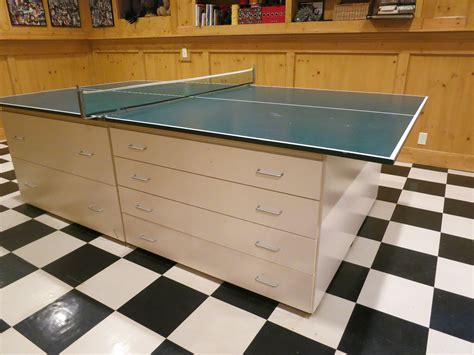 This ping pong table is built with compactness and easy storage in mind. Husband designed 4 same sized cabinets to support the ping ...