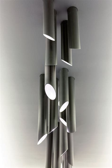 Shop online or in store! Tubes of matt black brass - light fixture for a boardroom ...