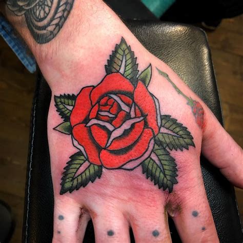 Traditional rose hand tattoo | Hand tattoos, Rose hand tattoo, Hand and finger tattoos