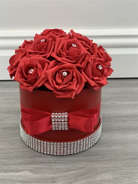 Prestige flowers always make sure you receive fresh. Artificial Flower Hat Box Red Diamante