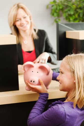 Young americans bank in denver, colorado, is the only bank in the entire world specifically designed for young people ages 21 and younger. Young Girl And Saving Piggy Bank With Retail Banking ...