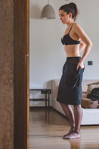 If you know a lady like that, you've probably met a cancer woman. Portrait Of A Young Woman At Home Getting Dressed And ...