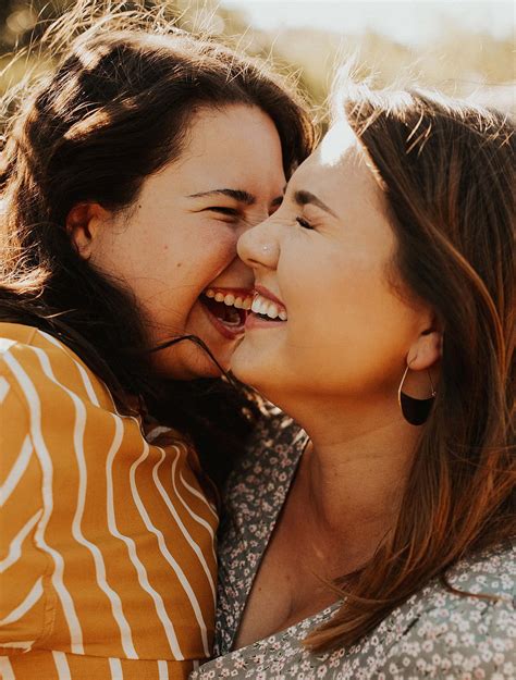 Download Two stylish lesbians smiling in joy | Wallpapers.com