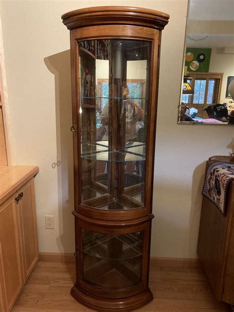 This curio is built of oak hardwood solids and veneers and an estate oak finish. Pulaski Corner curved display curio cabinet for Sale in ...