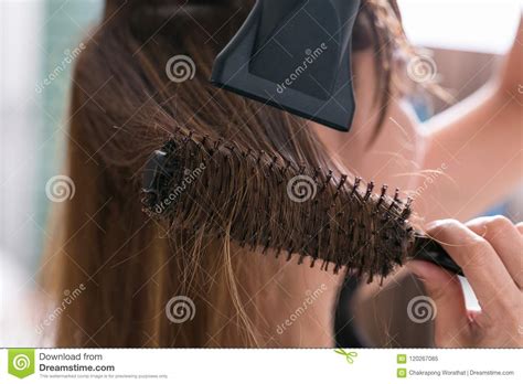 According to glenn ellis, stylist at marie robinson salon, using a round brush on dry hair. Drying Blond Hair With Hair Dryer And Round Brush. Stock ...