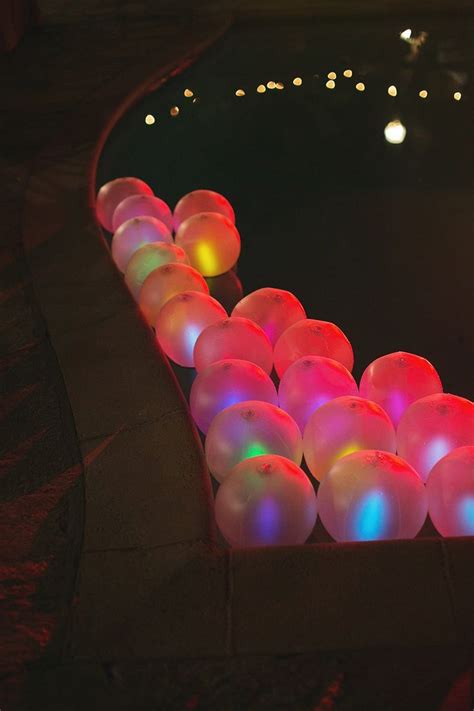 Neon party ideas, costumes, games & more. Balloons with glow sticks as pool decor. Event Design by ...
