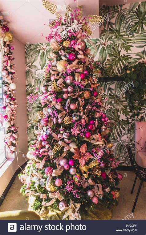 The traditional gold decorations have been combined with the trendy pink neon to bring colour and fun to the christmas table. Download this stock image: christmas tree with pink and gold ornaments - P1G0FF from Alamy's ...