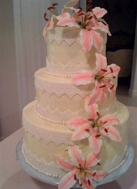 The bottom tier is lemon cake with raspberry filling and vanilla buttercream frosting. Three tier butter cream wedding cake with white and pink ...