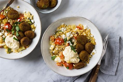 Scooped into hot flatbread with a chunky cucumber yoghurt salad and. couscous falafel hummus bowl - Feelgoodbyfood