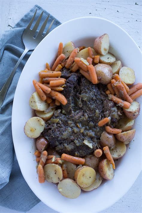 Arrange potatoes, onion, carrots, and celery around roast. How to Cook Pot Roast in the Instant Pot | A Bountiful Kitchen