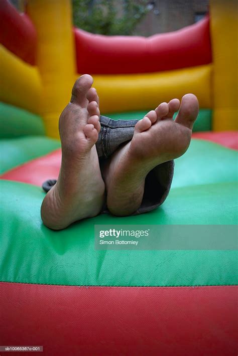 Dirty feet podcast, ottawa, ontario. Boy With Dirty Feet Lying In Bouncy Castle Closeup Of Feet ...