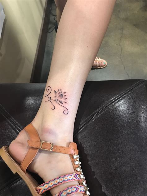 Different flower tattoos symbolize different things. Celtic lotus flower on the ankle representing going ...