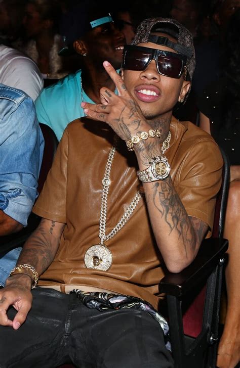 A beautiful tribal design is inked in red on blac's right hand and wrist. Tyga Arm Tattoo • Arm Tattoo Sites