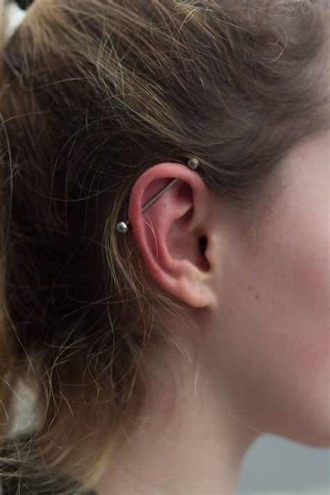 Thinking of going for a scaffold(industrial) piercing? Tremendous and Prodigious Industrial Piercing - Custom Tattoo Art