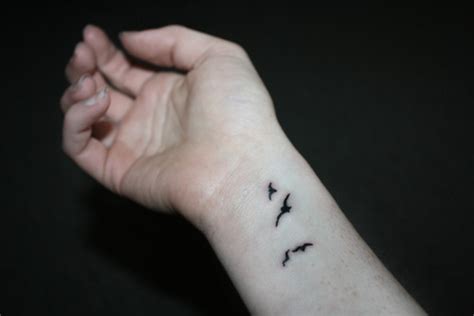 A circle, a straight line, a dot, etc. Small Birds Wrist Tattoo