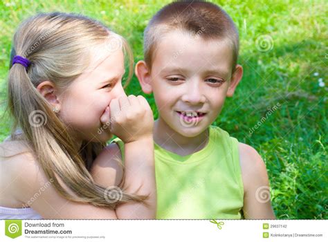 Little Girl Whispering Something To Her Brother Stock Photo - Image of ...