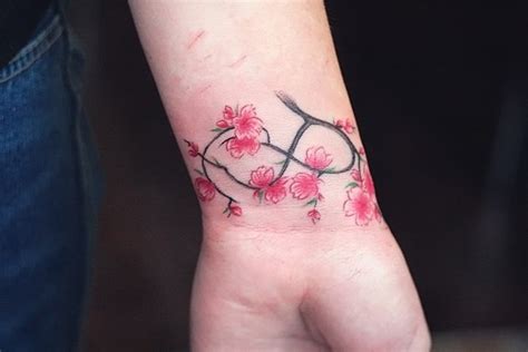 See more ideas about body art tattoos, blossom tree tattoo, blossom tattoo. Endless Sakura Wrist Tattoo | Best tattoo design ideas