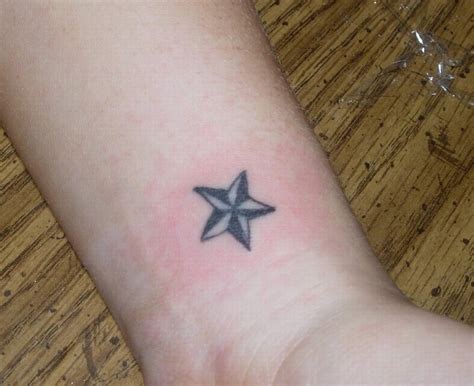 Triangle and human heart tattoo on side rib What Does A Star Tattoo Mean