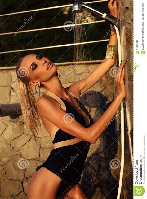 Search for the hot spring!! Sexy Blond Woman Taking Shower On Sunset Beach Stock Photo ...