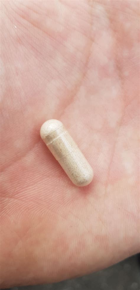 This capsule tablet I found on the floor. Contains a beige coloured ...