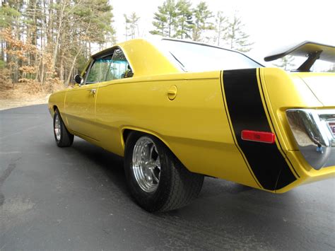 Double barrel polished rpm edelbrock aluminum intake on top of the holley carb peeking through the scoop. 1970 Dodge Dart Swinger Yellow | Letter G Decoration