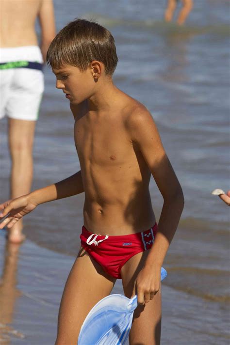 Friends playing at the copacabana's beach. speedo boy