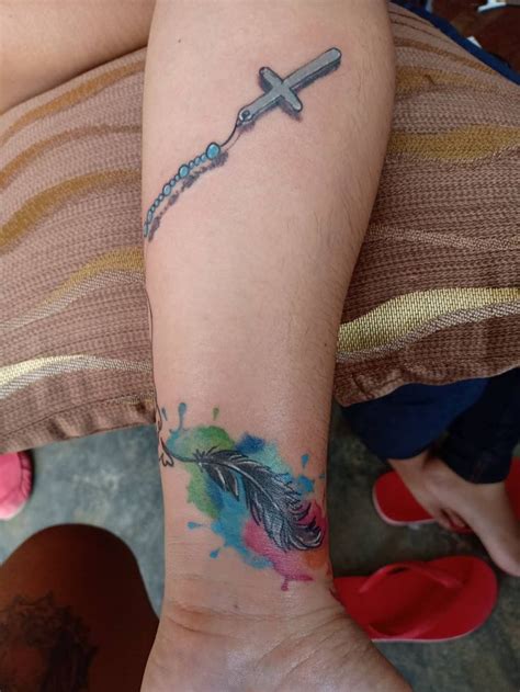 Birds flying from infinity feather tattoo by jeff ziozios. Feather Tattoo | Feather tattoo, Tattoos, Feather tattoos