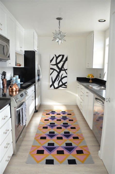 This gorgeous kitchen is fitted with dark gray kitchen cabinets, black hardware and matching black countertops. galley kitchen renovation reveal | Black kitchen handles, Galley kitchen renovation, Kitchen ...