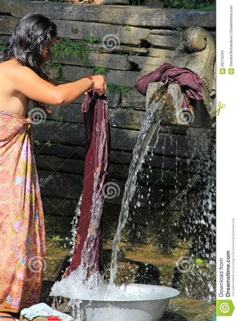 Washing clothes in cold water also helps preserve the condition and appearance of your clothing. Washing Clothes At The Waterpump Editorial Stock Image ...