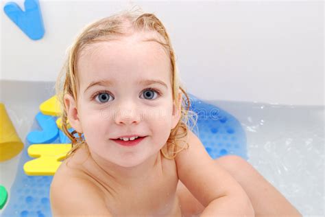 Taking a bath can help bring down your fever, but the really important part is that it can't be a cold bath. Bath baby stock image. Image of toddler, smile, baby, drip ...