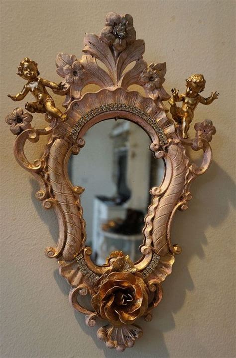 A pair of baroque style carved and gilded wood wall mirrors. Ornate cherub mirror wall hanging vintage pink and gold ...