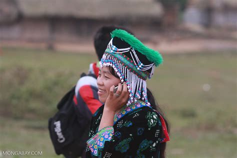 Hmong girl in traditional garb talking on a mobile phone