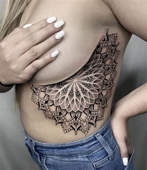 The rib cage is the arrangement of ribs attached to the vertebral column and sternum in the thorax of most vertebrates, that encloses and protects the vital organs such as the heart, lungs and great vessels. Mandala, Mystic, Woman Tattoo on Rib Cage ID:290