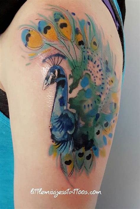 A watercolor tight tattoo adorns the sleeve. Jess Hannigan watercolor peacock tattoo | Small peacock ...