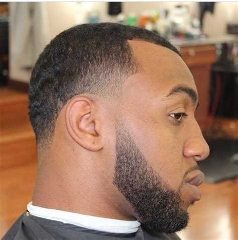 The curls on the top are styled in various ways, suiting one's appearance. 7 Terrific Taper Fade Haircuts with Beard - HairstyleCamp
