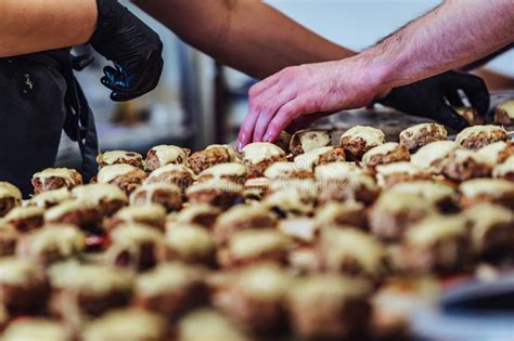 Regular testing will be conducted to maintain an ongoing audit of. Female And Male Chef Putting Ingredients Of Burgers On A ...