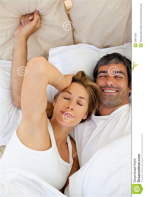Waking up in the bed and starting to. Beautiful couple waking up stock photo. Image of ...