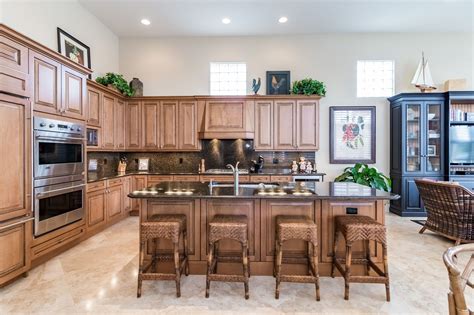 Navy blue & white transitional kitchen. The kitchen has custom Irpinia caramel colored maple wood cabinets, top-of-the-line GE monogram ...