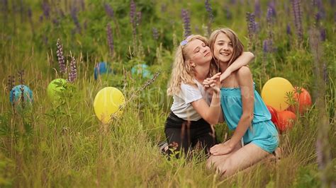 Farhan ahmed jovan, tanjin tisha, monoj pramanik, shahid un nabi. Two teen girls best friends sit on the grass and cuddling ...