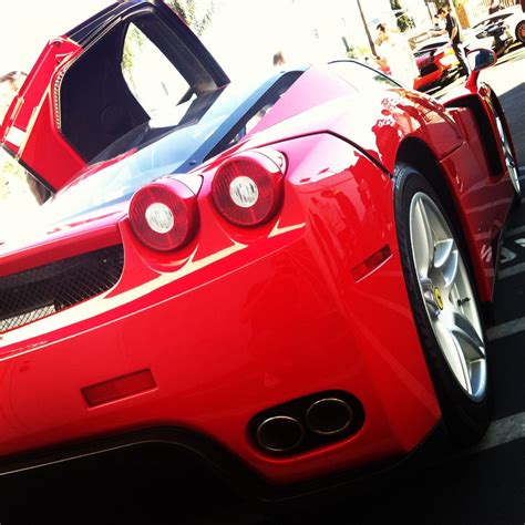 La luxury car rental offers: Back end of the classic red Ferrari Enzo at Lamborghini Newport Beach dealer super car show ...