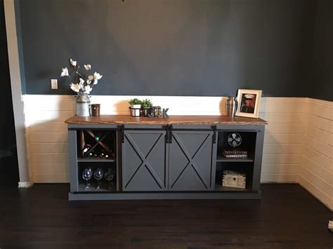 It is gorgeous with the rustic weathered wood and a beast of a storage unit with two sliding barn doors to cover the junk and four basket drawers to hold even more! Awesome Sliding Barn Door Ideas to Include in Your Home