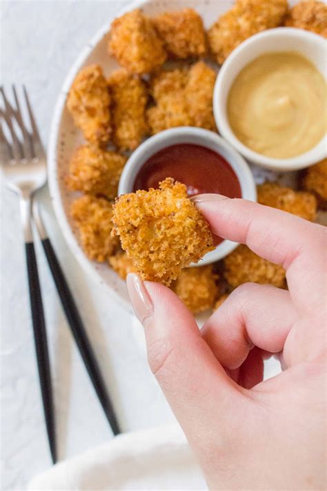 These healthy chicken nuggets are baked in the air fryer and get a crispy, golden, crunchy coating without added oil! Homemade Air Fryer Chicken Nuggets - Carmy - Run Eat Travel