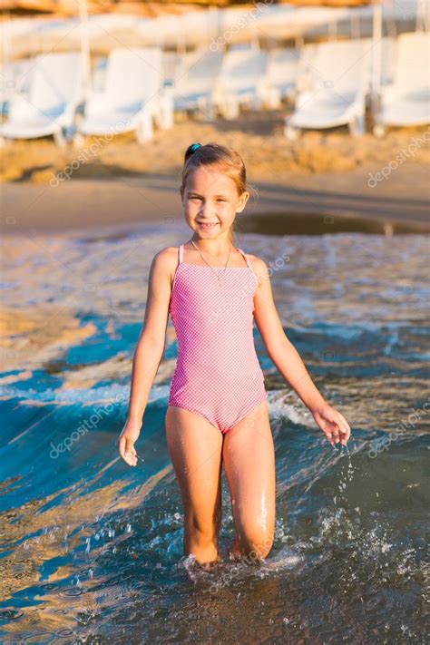 They probably wouldn't be so proud to be modelling what you're focusing on, if they knew the photo would be titled camel toe. Adorable little girl playing in the sea on a beach — Stock ...