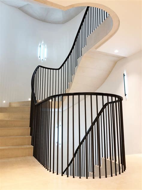 The railing features a gridlike design for safety and style. Curved stone staircase sweeps down with a handrail design to maintain a modern look and feel # ...