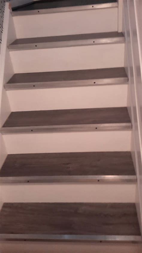 He uses laminate flooring instead of ceiling tiles. Laminate flooring on stairs | Basement remodeling ...