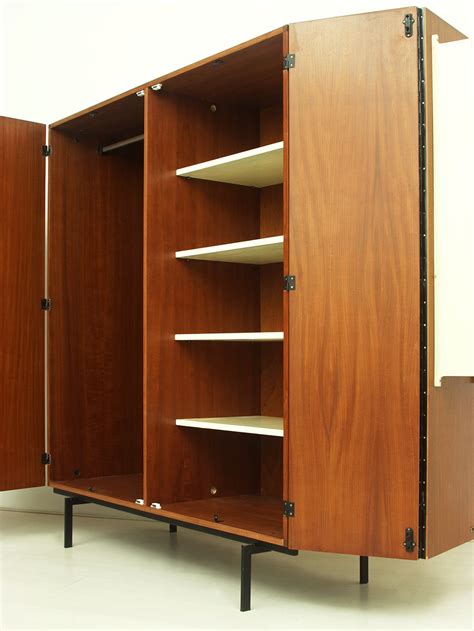 Panels provide a sense of privacy, refuge and organization in primary workspaces, while open weave screens and glass elements delineate space between primary and activity spaces without blocking light. Teak & Metal Wardrobe • Model KU14 | Good Old Vintage ...